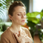 Woman practicing mindful breathing to calm the nervous system and reduce stress.