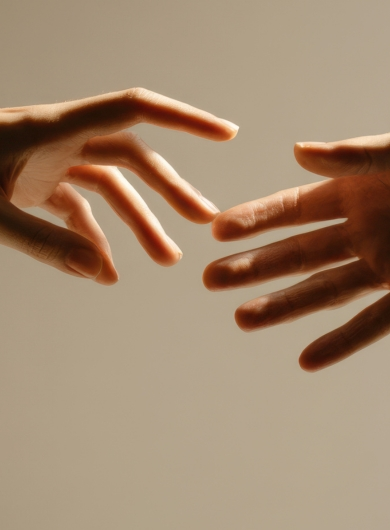 Hands in light and shadow reaching toward unity and embracing inner light and shadow