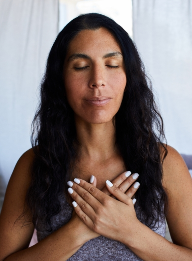 Hands resting over the heart as a grounding gesture for finding your way out of the darkness