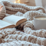 Coffee and open book on unmade bed representing rest during a busy and overextended season