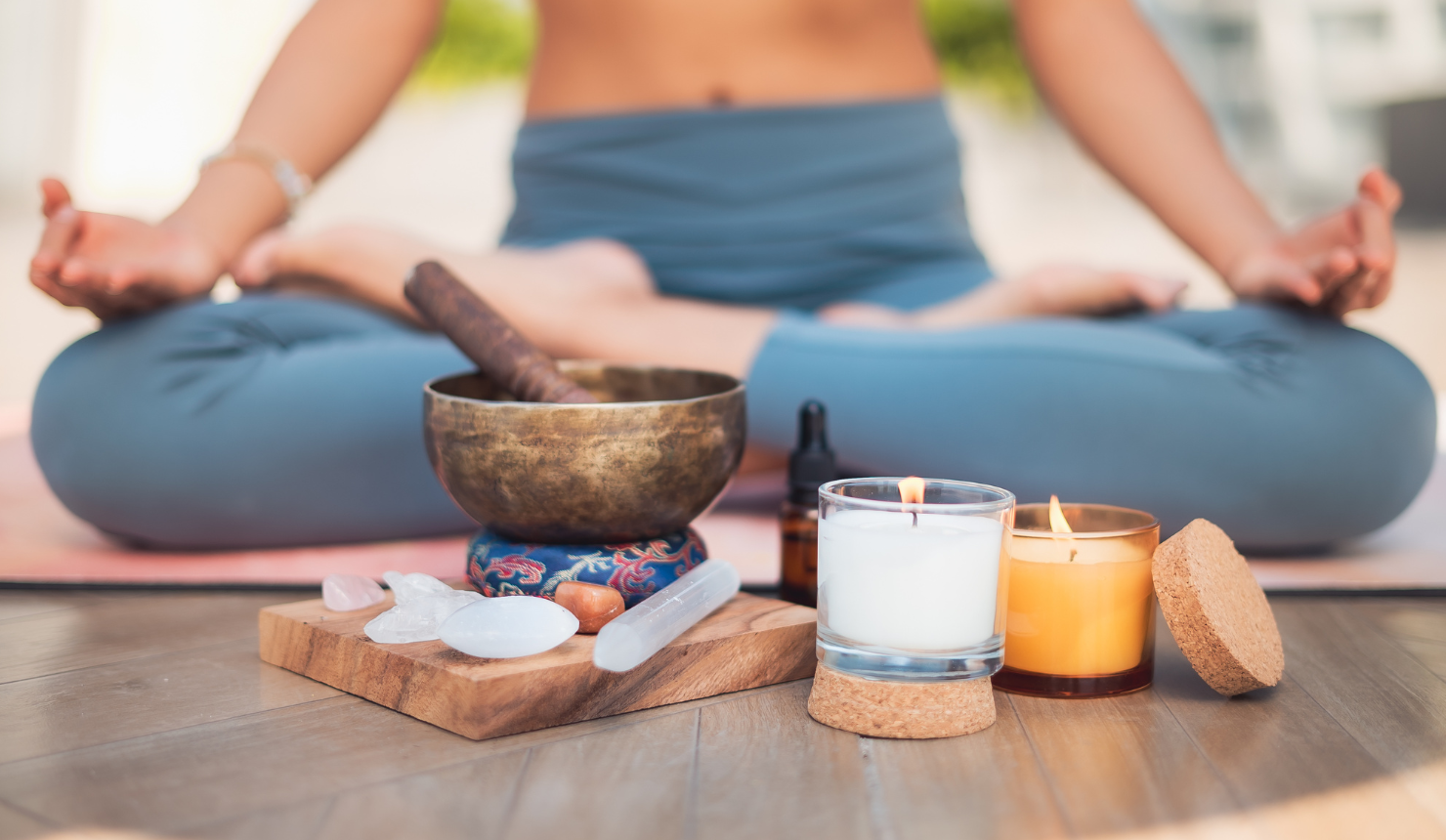 Woman sitting on the floor practicing grounding after noticing signs your chakras are out of balance