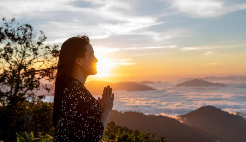 Woman standing outdoors at sunrise representing courage and healing