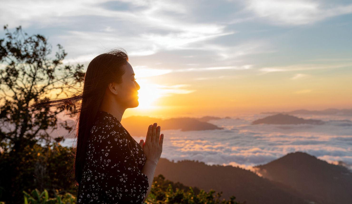 Woman standing outdoors at sunrise representing courage and healing