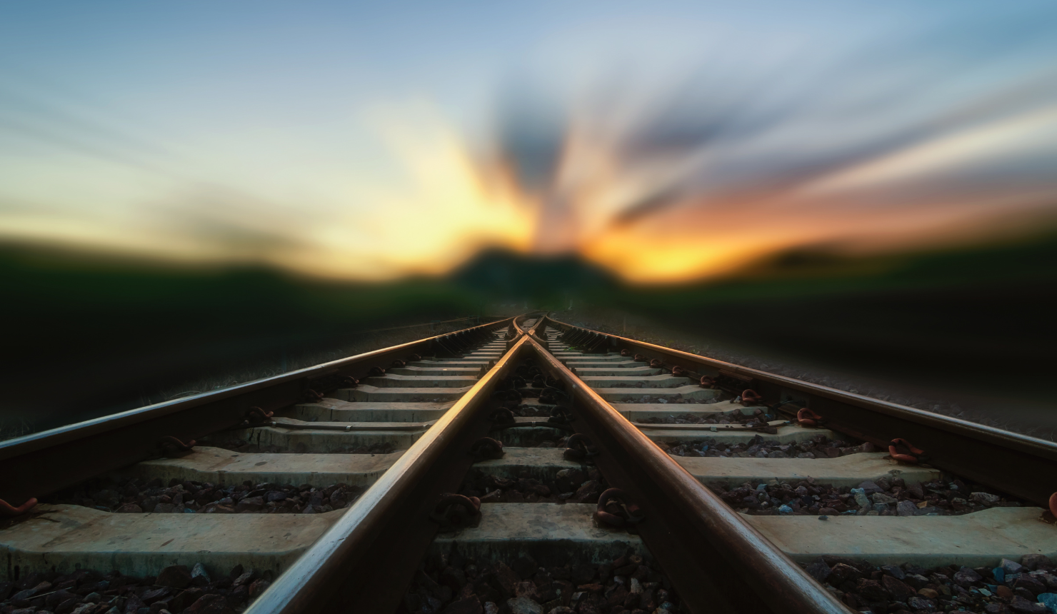Railroad tracks stretching toward a glowing sunrise, symbolizing change, new beginnings, and the journey of personal growth.