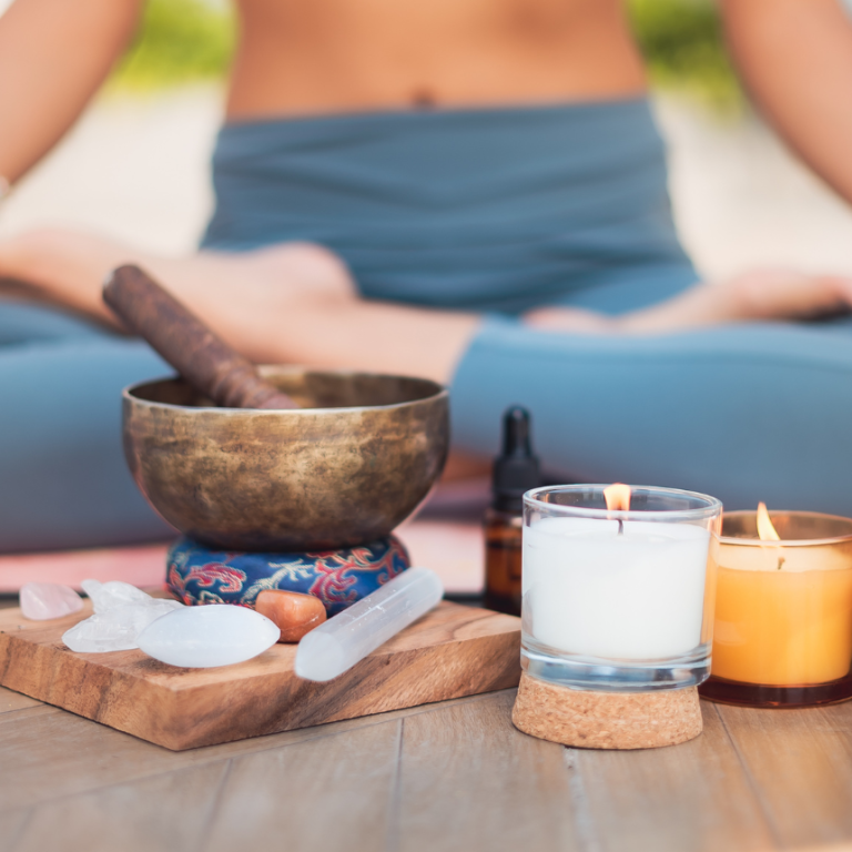 Woman sitting on the floor practicing grounding after noticing signs your chakras are out of balance